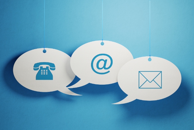 white chat bubbles with phone, an "at" symbol and envelope icons
