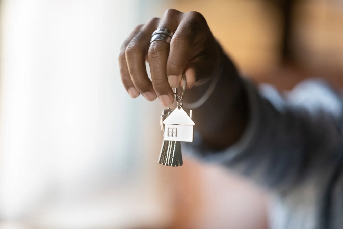 a hand hold new keys to a home