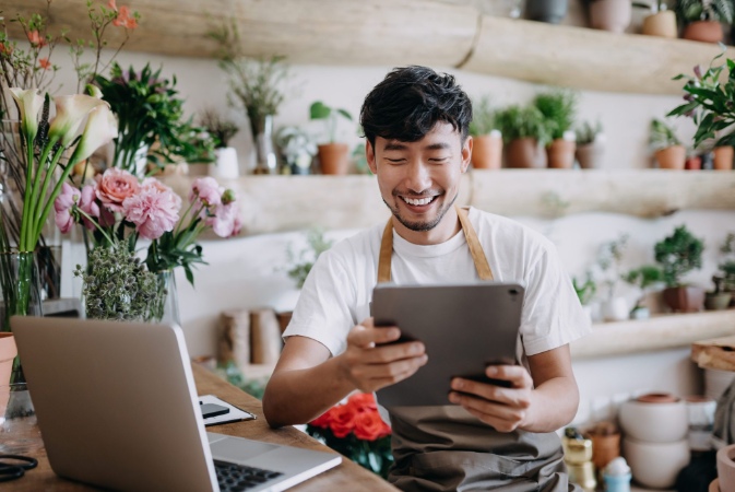 a small business owner viewing their tablet
